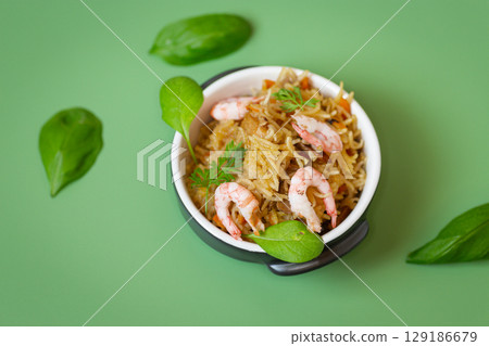 Appetizing rice with seafood and vegetable garnish 129186679