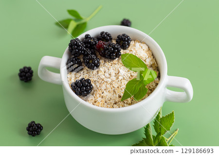 Breakfast oatmeal with blackberries and mint 129186693
