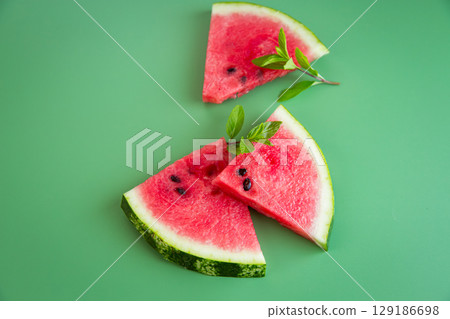 Summer refreshing still life with watermelon and green background 129186698