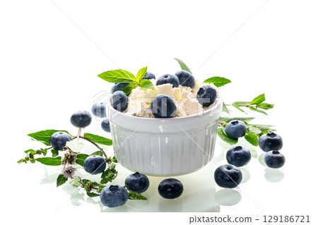 Healthy breakfast cottage cheese with blueberries on a white background Healthy breakfast cottage cheese with blueberries on a white background 129186721