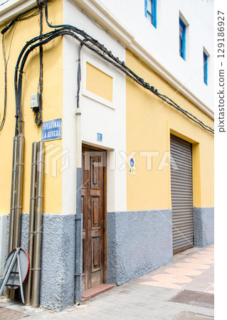 White and pastel-colored buildings in bright sunlight, Betancuria townscape on Fuerteventura island 129186927