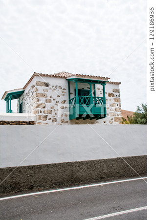 A streetscape with white-walled buildings in bright sunlight in Betancuria, Fuerteventura A streetscape with white-walled buildings in bright sunlight in Betancuria, Fuerteventura 129186936