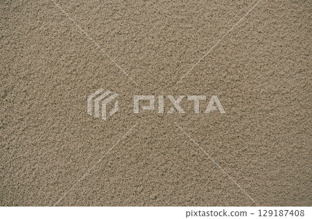 Sandy brown textured background with small grains 129187408