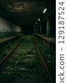 Flowers blooming in an abandoned station and subway tracks covered in nature 129187524