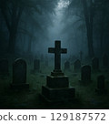 A cemetery and a gravestone cross in a foggy forest. Horror, haunted, spooky landscape photography. 129187572