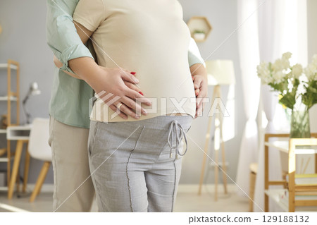 Loving couple belly hug, future parents expecting first baby close husband and pregnant wife 129188132