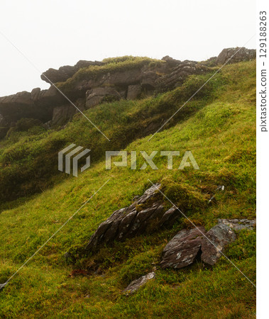 View of the Coomloughra Horseshoe mountainside on a foggy day in Ireland. 129188263