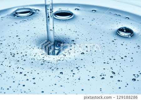 Shampoo or shower gel is poured from above and shows a bubbly texture. Shampoo or shower gel is poured from above and shows a bubbly texture. 129188286