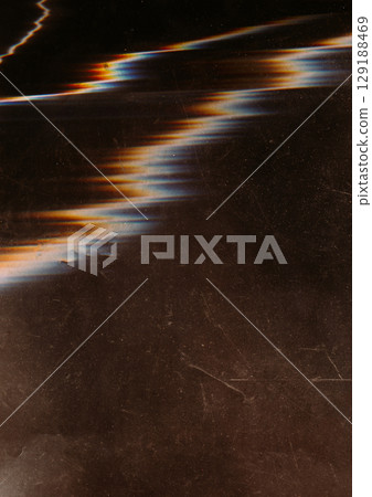 Distorted display blur. System breakdown. Wave glowing color glitch zigzag line on black scratched glass screen abstract background. 129188469