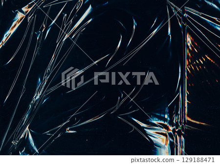 Creased plastic. Glued background. Folded distressed foil cellophane. Color scratch line flash on black abstract blur sheet screen. 129188471
