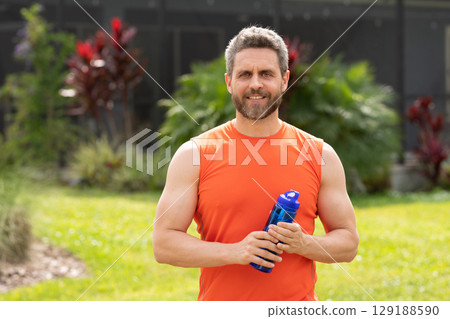 Healthy lifestyle. Water balance in body. Sport man feel thirst drinking water. Hydration vitality advertisement. Thirsty runner after workout. Thirsty man drink water. Sport runner man has thirst Healthy lifestyle. Water balance in body. Sport man feel thirst drinking water. Hydration vitality advertisement. Thirsty runner after workout. Thirsty man drink water. Sport runner man has thirst 129188590