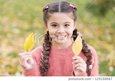 Small child with autumn leaves. Happy little girl in autumn forest. Happy childhood. School time. Autumn leaves and nature. Trendy beauty. Feeling comfortable. Time to rest. In love with nature Small child with autumn leaves. Happy little girl in autumn forest. Happy childhood. School time. Autumn leaves and nature. Trendy beauty. Feeling comfortable. Time to rest. In love with nature 129188667