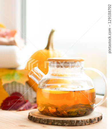 warm tea on the windowsill, cozy autumn atmosphere, pumpkin, leaves warm tea on the windowsill, cozy autumn atmosphere, pumpkin, leaves 129188702