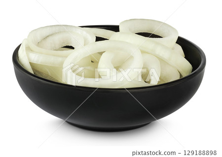 Onion slices in a ceramic bowl isolated on a white background. Onion slices in a ceramic bowl isolated on a white background. 129188898