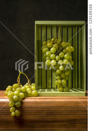 Still life with ripe large bunches of grapes Still life with ripe large bunches of grapes 129189168
