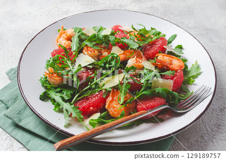 Fresh shrimp salad with arugula, grapefruit, and parmesan served in a bowl Fresh shrimp salad with arugula, grapefruit, and parmesan served in a bowl 129189757