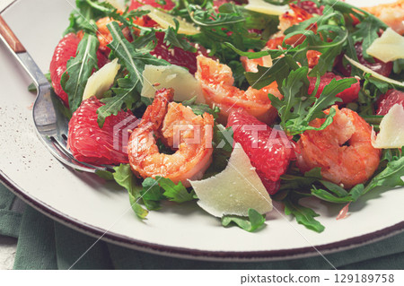 Fresh shrimp salad with arugula, grapefruit, and parmesan served in a bowl Fresh shrimp salad with arugula, grapefruit, and parmesan served in a bowl 129189758