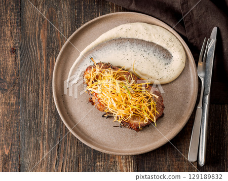 Beef or pork steak with shoestring fries onion and potatoes puree. Restaurant style plating beefsteak. Food and cuisine concept. Delicious pork steak. BBQ rib beefsteak or tender pork steak 129189832