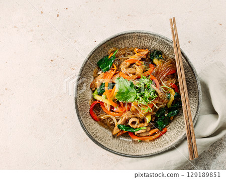 Asian noodles with meat and vegetables. Stir fry noodles with vegetables and beef, pork or chicken. Plate of asian buckwheat soba noodles with vegetables and chicken. Asian noodles with meat and vegetables. Stir fry noodles with vegetables and beef, pork or chicken. Plate of asian buckwheat soba noodles with vegetables and chicken. 129189851