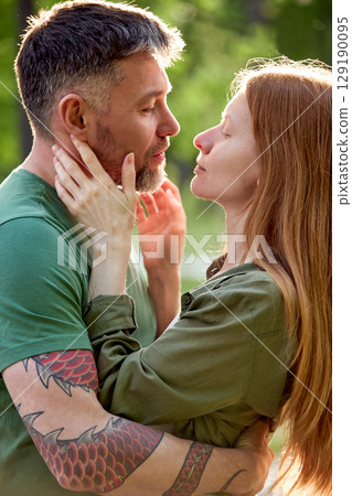 Affectionate Couple Sharing a Romantic Moment Outdoors in Natural Light 129190095