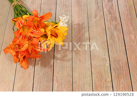 Beautiful bouquet of daylily and lily flowers, summer sunny postcard. Abstract floral composition and elegant beauty concept, background for eco-products display. Advertising banner Beautiful bouquet of daylily and lily flowers, summer sunny postcard. Abstract floral composition and elegant beauty concept, background for eco-products display. Advertising banner 129190528