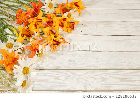 Advertising banner with beautiful flowers of garden chamomile and lily, summer sunny postcard. Abstract floral composition and elegant beauty concept, background for eco-products display 129190532