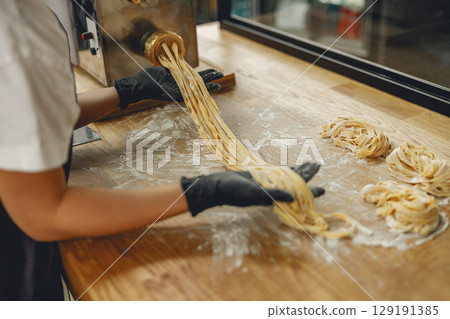 Handmade Pasta Preparation Techniques Emphasizing Artisan Skills in a Culinary Setting for All 129191385