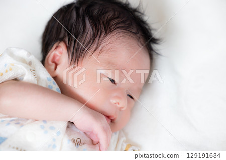 Newborn baby taking a nap Newborn baby taking a nap 129191684