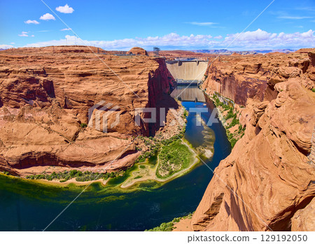 Aerial Fly Over Glen Canyon Dam Colorado River and Red Sandstone Cliffs Aerial Fly Over Glen Canyon Dam Colorado River and Red Sandstone Cliffs 129192050