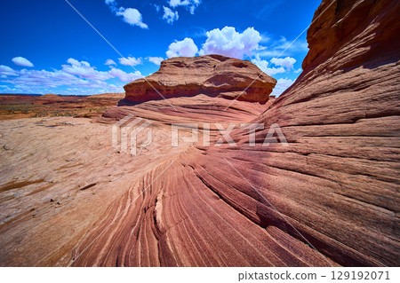 Sweeping Red Sandstone Waves and Butte under Blue Sky Arizona Desert 129192071
