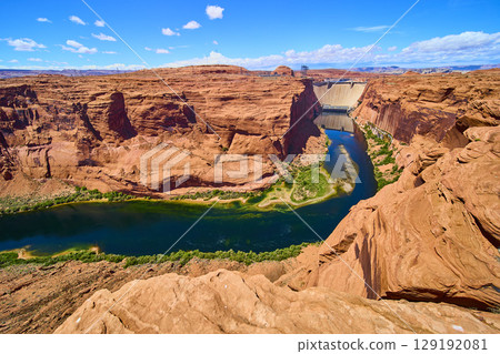 Glen Canyon Dam and Colorado River with Red Sandstone Cliffs Aerial Fly Over 129192081