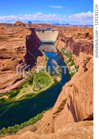 Aerial Fly Over Glen Canyon Dam Colorado River and Red Sandstone Cliffs Aerial Fly Over Glen Canyon Dam Colorado River and Red Sandstone Cliffs 129192114