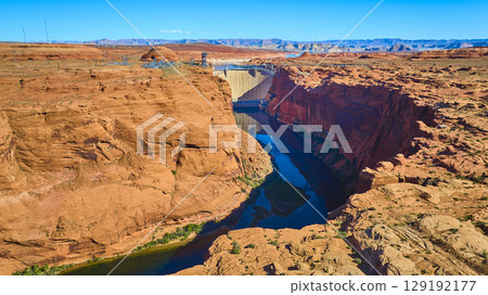 Aerial Glen Canyon Dam Colorado River and Red Sandstone Cliffs Fly Over View Aerial Glen Canyon Dam Colorado River and Red Sandstone Cliffs Fly Over View 129192177