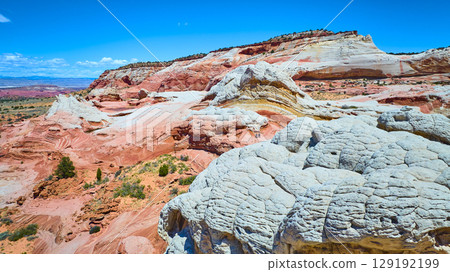 Aerial Through of White Pocket Sandstone Layers and Swirling Vermilion Cliffs Aerial Through of White Pocket Sandstone Layers and Swirling Vermilion Cliffs 129192199