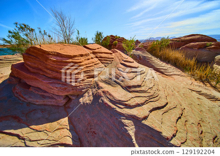 Layered Red Sandstone Formations with Desert Vegetation at Ground Level 129192204