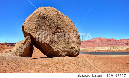 Balanced Red Boulder Desert Road and Mesas Eye Level View Balanced Red Boulder Desert Road and Mesas Eye Level View 129192227
