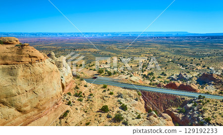 Aerial Fly Over Sandstone Cliff Desert Plain and Winding Road Marble Canyon 129192233