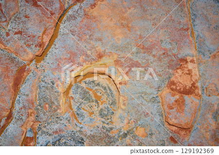 Desert Rock Texture with Swirling Mineral Patterns Top Down View Desert Rock Texture with Swirling Mineral Patterns Top Down View 129192369