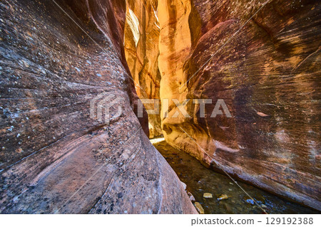Sandstone Slot Canyon Walls with Flowing Stream and Sunlight Low Perspective Sandstone Slot Canyon Walls with Flowing Stream and Sunlight Low Perspective 129192388