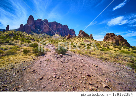 Rugged Superstition Mountains Cliffs Desert Trail and Shrubs Eye Level View Rugged Superstition Mountains Cliffs Desert Trail and Shrubs Eye Level View 129192394