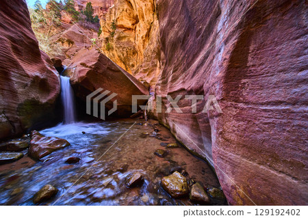 Kanarra Falls Waterfall Motion Over River Rocks in Colorful Slot Canyon Eye Level 129192402