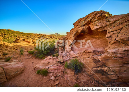 Red Sandstone Cave and Desert Shrubs at Golden Hour Eye Level Perspective 129192480