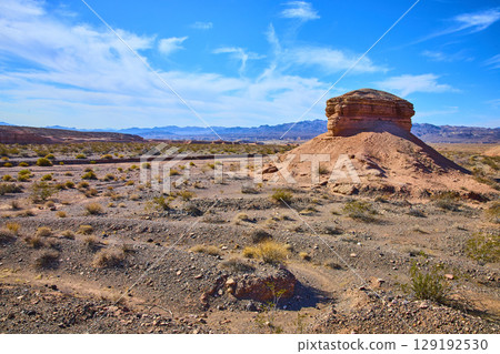 Majestic Desert Rock Formation Under Blue Sky Eye-Level Perspective 129192530