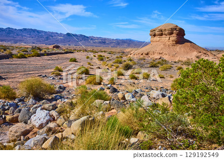 Desert Butte and Mountains Under Clear Sky at Eye-Level Perspective 129192549