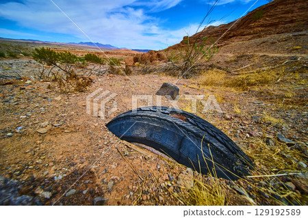 Abandoned Tire in Desert Landscape Low Ground Perspective 129192589