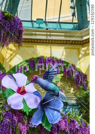 Vibrant Hummingbird Sculpture in Bloom at Bellagio Gardens Eye-Level View 129192590