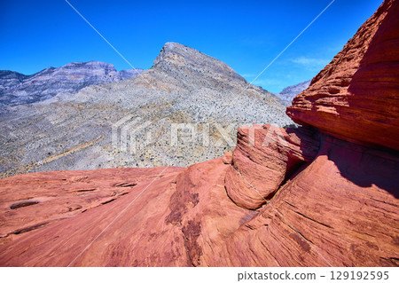 Red Rock Canyon Sandstone Formations with Mountain Backdrop Eye-Level View 129192595