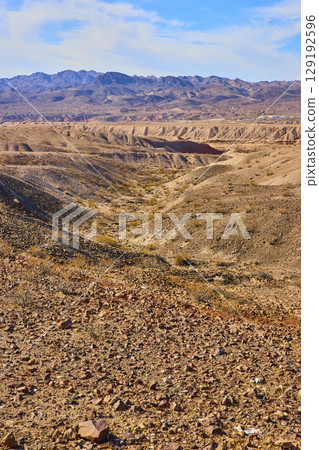 Rugged Desert Landscape with Mountains and Shrubs Eye-Level View 129192596