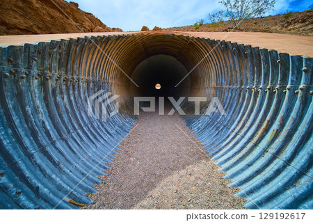Corrugated Metal Culvert in Desert with Vanishing Point Perspective 129192617