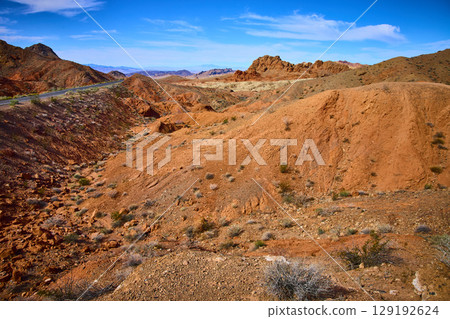 Desert Landscape with Rugged Hills and Road Eye-Level Perspective Desert Landscape with Rugged Hills and Road Eye-Level Perspective 129192624